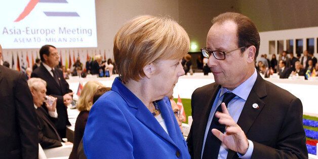 German Chancellor Angela Merkel, left, shares a word with French President Francois Hollande at the 10th Asia-Europe Meeting (ASEM) in Milan, Italy, Thursday, Oct. 16, 2014. (AP Photo/Daniel Dal Zennaro, Pool)