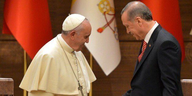 Turkish President Recep Tayyip Erdogan (R) shakes hands with Pope Francis following their joint press conference at Turkey's Presidential Palace on November 28, 2014 in Ankara. AFP PHOTO/ADEM ALTAN (Photo credit should read ADEM ALTAN/AFP/Getty Images)
