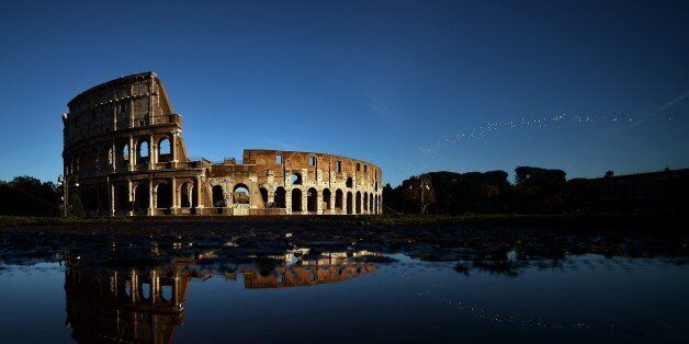 The Colosseum reflects in the water on November 21, 2014 in Rome. AFP PHOTO / FILIPPO MONTEFORTE (Photo credit should read FILIPPO MONTEFORTE/AFP/Getty Images)