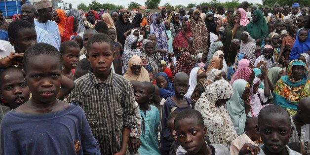 Civilians who fled their homes following an attack by Islamist militants in Bama, take refuge at a school in Maiduguri, Nigeria, Tuesday, Sept. 9, 2014. Fleeing residents say Boko Haram fighters are patrolling 50 kilometers (32 miles) of the main road between two of several towns the Islamic extremists have seized in a 200-mile (320-kilometer) arc running alongside northeast Nigeria's border with Cameroon. (AP Photo/Jossy Ola)