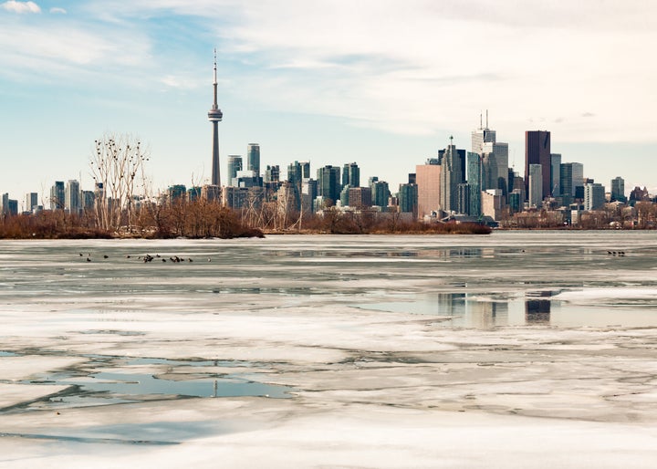 The Toronto skyline is seen here during the winter with melting ice covering Lake Ontario. Research suggests future winters will be warmer and more rainy in Canada's largest city. 