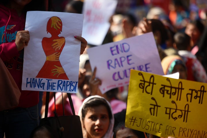 People hold placards during a sit-in protest as Delhi Commission for Women chairperson Swati Maliwal sits on indefinite hunger strike against the Hyderabad rape and murder. She said, "I won't get up until I get assurance from centre that rapists will be served death penalty within 6 months. Police accountability needs to be set." 