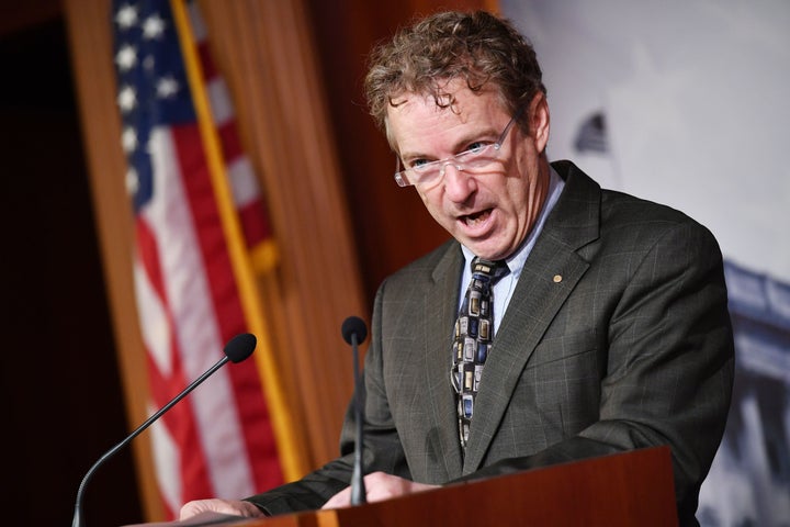 Sen. Rand Paul (R-Ky.) reads the "whistleblower" question blocked by Supreme Court Chief Justice John Roberts during the impeachment trial proceedings of President Donald Trump on Capitol Hill Jan. 30.