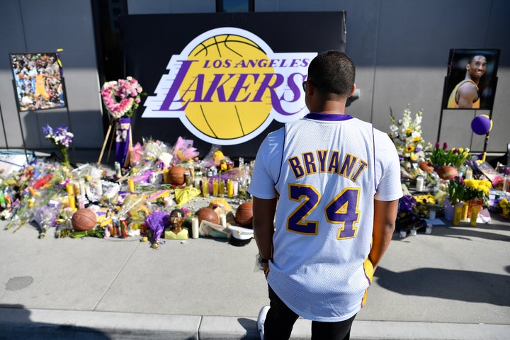 Fans pay their respects at a makeshift memorial for Kobe Bryant in LA.