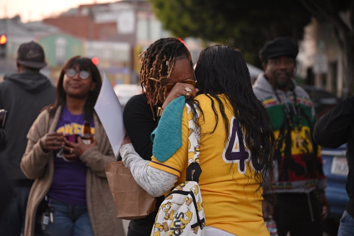 Distraught fan Naima Smith (wearing glasses) crying at a vigil for Kobe Bryant in LA on Sunday.