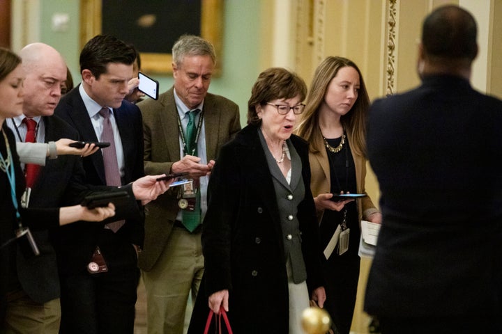 Sen. Susan Collins (R-Maine) is trailed by reporters as she arrives Thursday before the Senate impeachment trial. Collins announced late Thursday that she favors allowing witnesses.