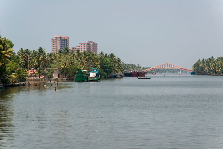 Mata Amritanandamayi's high-rise building ashram beside a water canal and between palm trees in the middle of Kerala's backwaters.