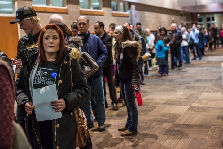 Democratic caucusgoers wait on line to caucus in West Des Moines, Iowa, on Feb. 1, 2016. 