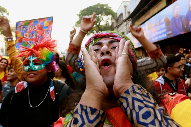 Members of LGBTQ community hold a rainbow flag as they take part in the pride parade and protest against...