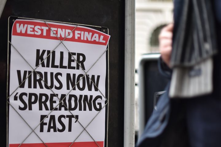 LONDON, ENGLAND - JANUARY 31: People walk past a news banner stating "Killer virus now spreading fast" at Bank station on January 31, 2020 in London, England. The World Health Organization declared a global health emergency over the coronavirus outbreak, saying there have been 98 cases outside China. Today, two cases of the virus have been confirmed in the UK. (Photo by John Keeble/Getty Images)