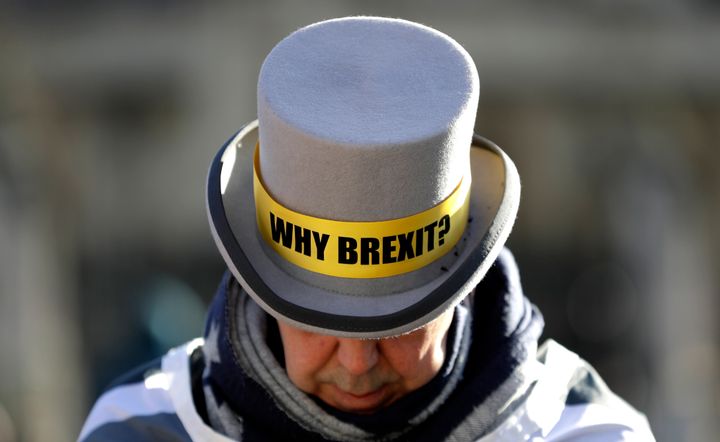 Why Brexit? written on the hat of anti-Brexit campaigner Steve Bray as he stands outside parliament in London