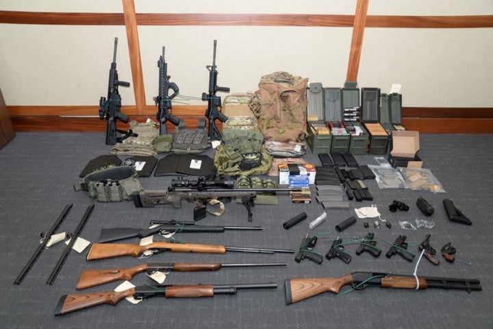 A handout photo provided by the U.S. attorney’s office for the District of Maryland of the collection of weapons and am