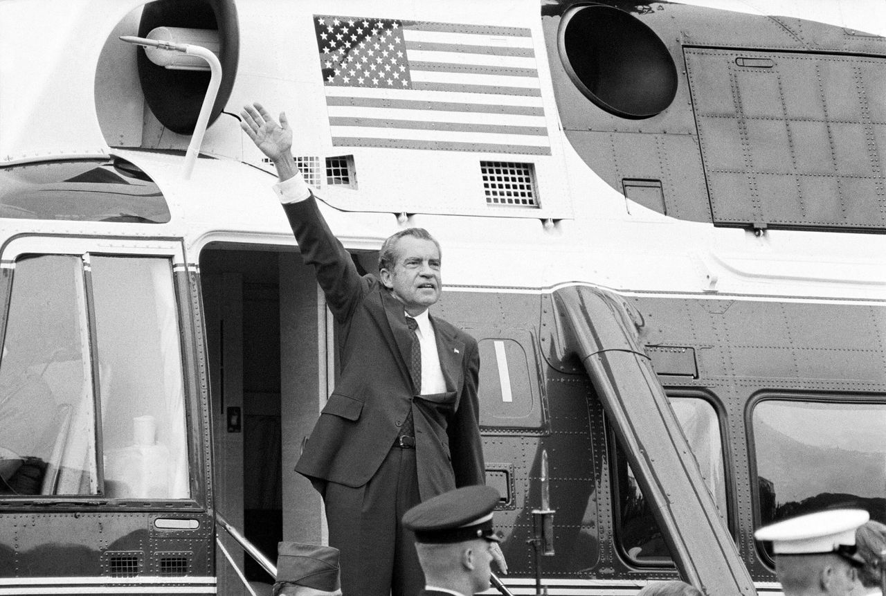 President Richard Nixon waves goodbye from the steps of his helicopter outside the White House after resigning from office for abusing his power.