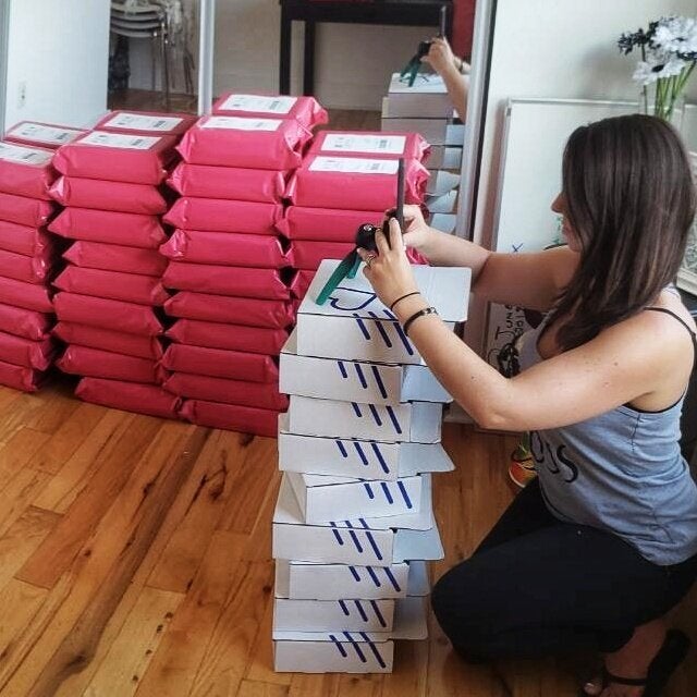Hoy sets up an at-home photo shoot for Brave Crate, using boxes with the original Brave Crate design.