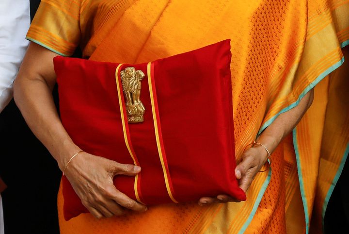 Finance Minister Nirmala Sitharaman holds budget papers on Saturday as she leaves her office to present the budget in the Parliament.