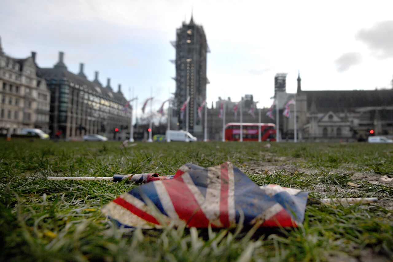 Union flags left discarded on the mud and grass at Parliament Square in London.