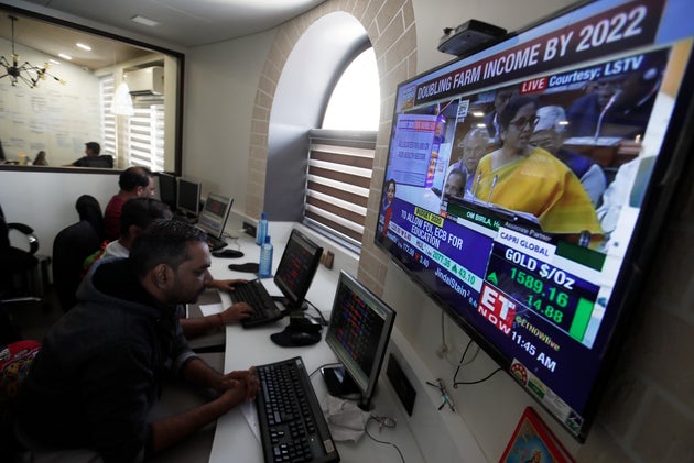 Brokers work at their computer terminal at a stock brokerage firm in Mumbai, India, February 1,