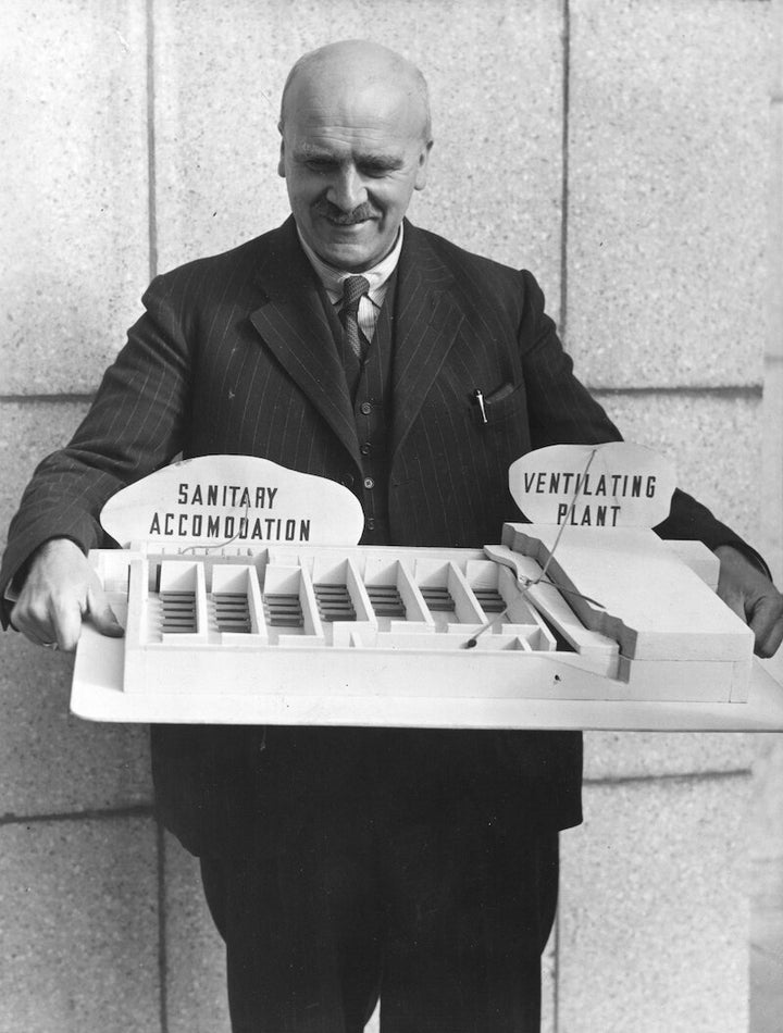 JBS Haldane holds a model of a Haldane shelter, July 1940. © Arthur Tanner