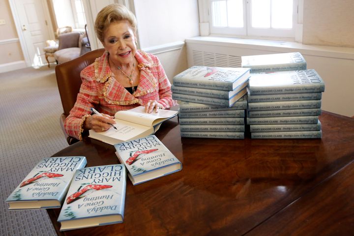 Clark signs copies of her book "Daddy's Gone A Hunting" at the Simon & Schuster office in New York in 2013.