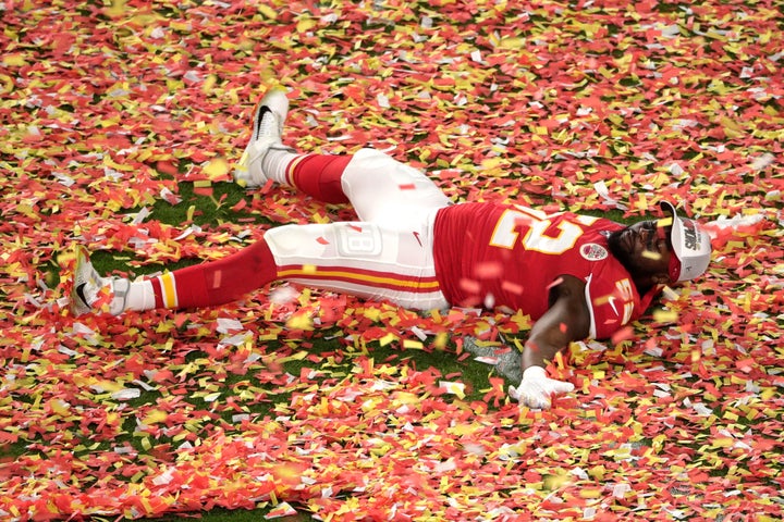 Kansas City Chiefs' Demone Harris plays with the confetti at the end of the Super Bowl.