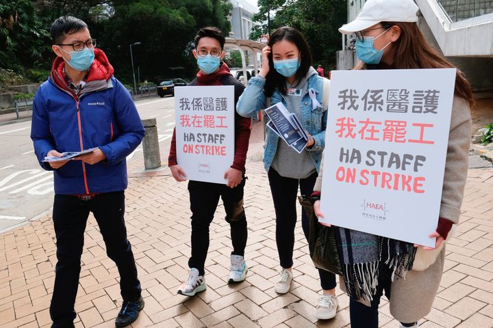Medical workers hold a strike near Queen Elizabeth Hospital as they demand Hong Kong close its border with China 