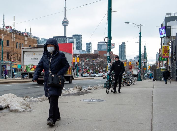 A pedestrian wears a protective mask in Toronto on Jan. 27, 2020.