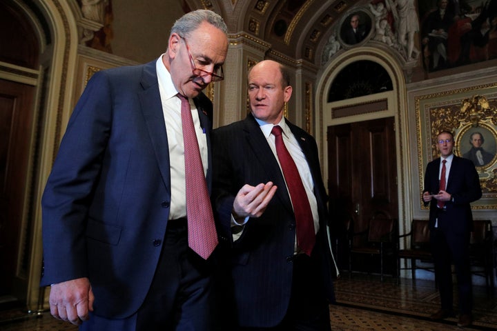 U.S. Senate Minority Leader Chuck Schumer (D-N.Y.) and Sen. Chris Koons (D-Del) walk together prior to the resumption of the