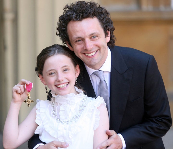 Michael Sheen and his daughter Lily with the Order of the British Empire he received from Queen Elizabeth II during investitures at Buckingham Palace on June 2, 2009.