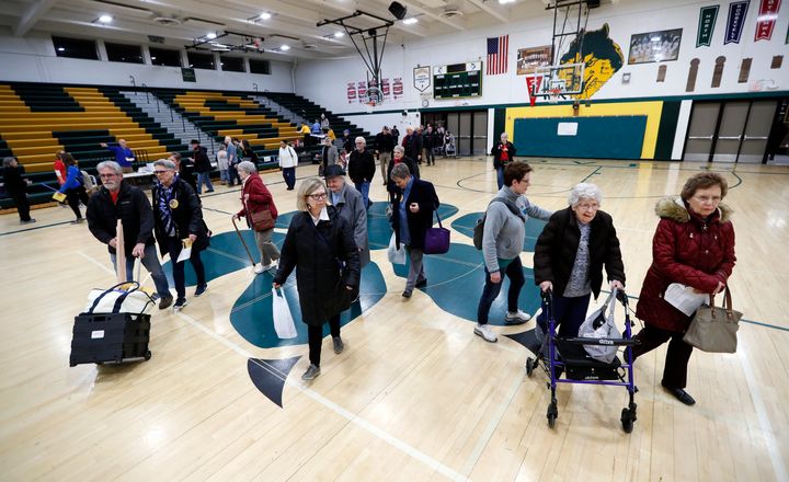 Des Moines, Iowa, residents enter a caucus site at Hoover High School on Monday.