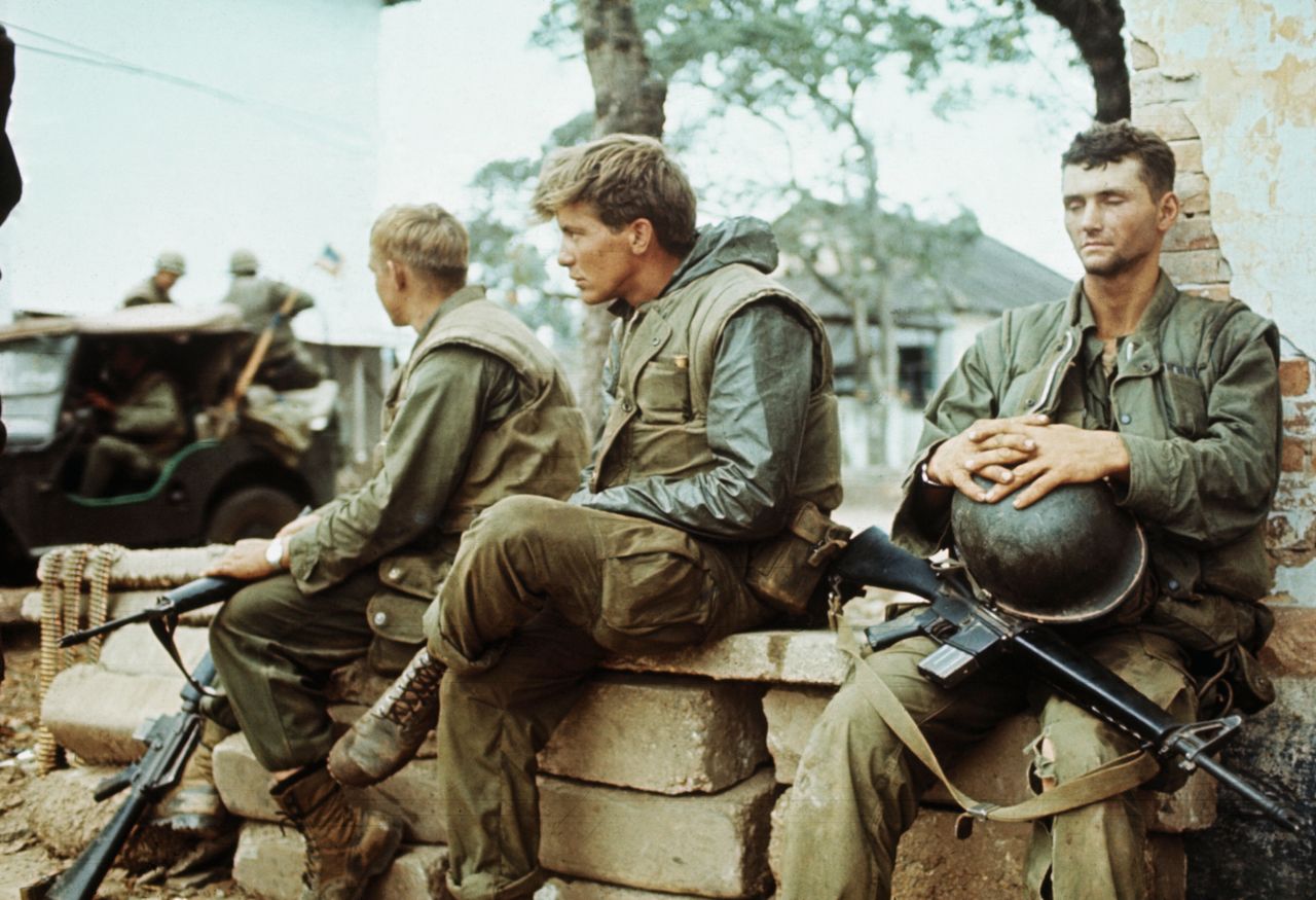 (Original Caption) During pause in fighting between allied and communist troops, two young U.S. Marines - their faces reflecting their weariness - sit sad-faced and idle for a moment.