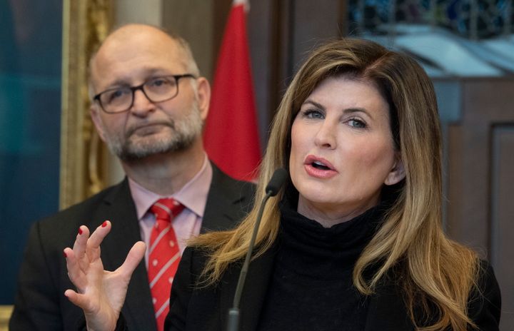 Attorney General David Lametti looks on as Rona Ambrose speaks about a government bill that would require federal judges take sexual assault law training. They made the announcement in Ottawa, on Feb. 4, 2020. 