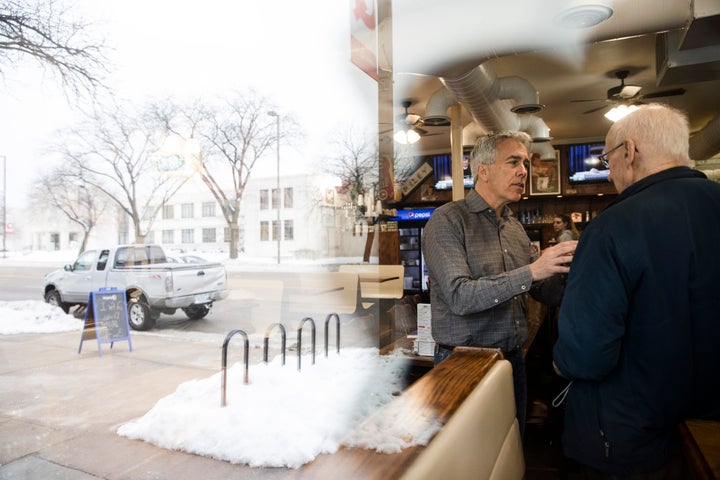 Republican presidential candidate Joe Walsh (center) is seen through a window during a campaign event at Riley's Cafe on Jan. 29, 2020, in Cedar Rapids, Iowa.