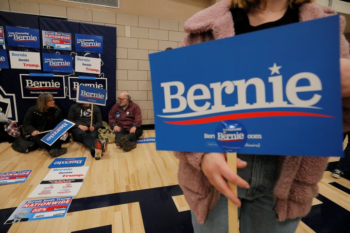 Supporters of Sen. Bernie Sanders (I-Vt.) wait at their caucus site in Des Moines on Monday. Iowans are defensive of the cauc