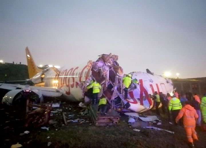 Officials work around the site after a passenger plane skidded off the runway in Istanbul Sabiha Gokcen International Airport, breaking into two, on February 05, 2020 in Istanbul, Turkey. 