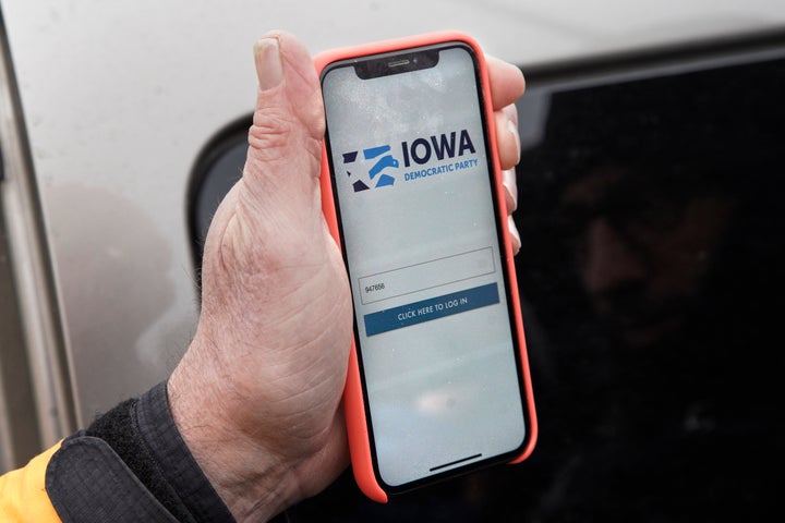 Precinct captain Carl Voss of Des Moines displays the Iowa Democratic Party caucus reporting app on his phone outside of the
