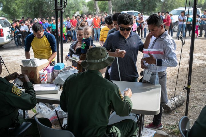 U.S. Border Patrol agents interview immigrants, including a blind man from El Salvador, after taking them into custody in July in Los Ebanos, Texas.
