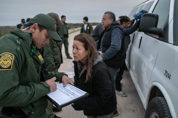 U.S. Border Patrol agents detain undocumented immigrants near a section of a privately built border wall near Mission, Texas, in December.