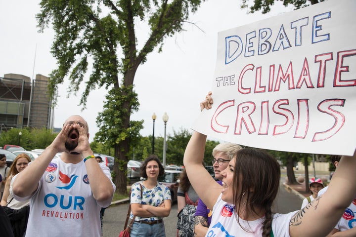 Protests calling on the DNC to host a climate debate last summer. 