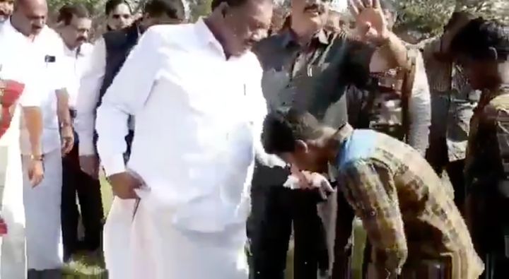Forest Minister Dindigul C Sreenivasan has children from the tribal community remove his slippers.