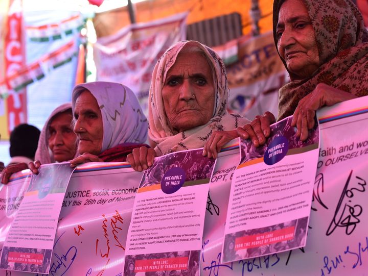 Women hold posters of the preamble to the Constitution during the ongoing protest against Citizenship Amendment Act (CAA) at Shaheen Bagh, on February 1, 2020.