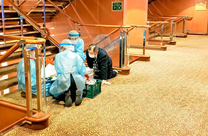 Medical workers on the cruise ship Diamond Princess anchored off Yokohama, south of Tokyo, in a photo taken by a passenger on