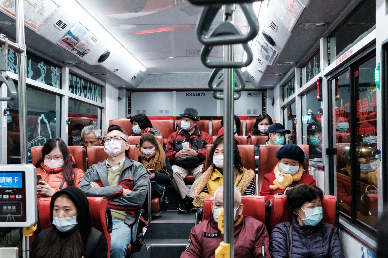 People wearing surgical masks on a bus in Taipei, Taiwan