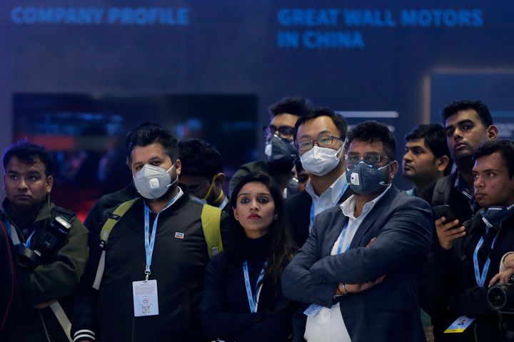 Delegates wear face mask as they attend an event at the Auto Expo in Greater Noida, near New Delhi, India.
