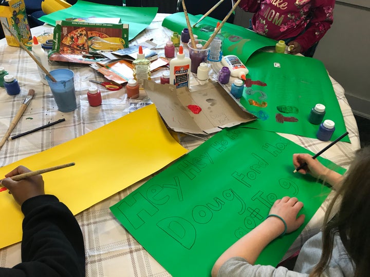 A child makes a poster taking aim at Premier Doug Ford during an elementary teachers' strike in Toronto, Ont. on Feb. 6, 2020.