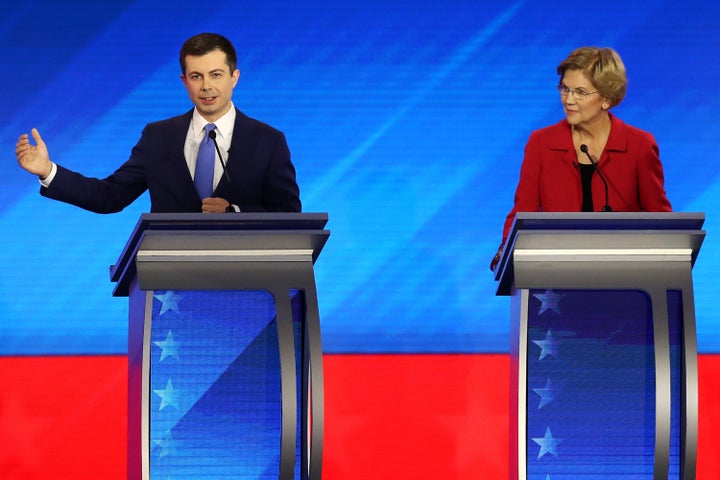 Former South Bend, Indiana, Mayor Pete Buttigieg and Sen. Elizabeth Warren (D-Mass.) participate in the Democratic presidential primary debate in the Sullivan Arena at St. Anselm College on Feb. 7 in Manchester, New Hampshire.