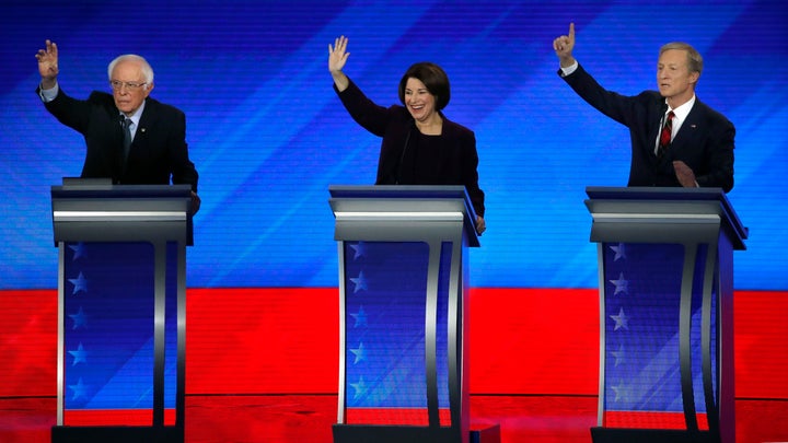 Democratic presidential candidates from left, Sen. Bernie Sanders, I-Vt., Sen. Amy Klobuchar, D-Minn., and businessman Tom Steyer try to be recognized during a Democratic presidential primary debate, Friday, Feb. 7, 2020.