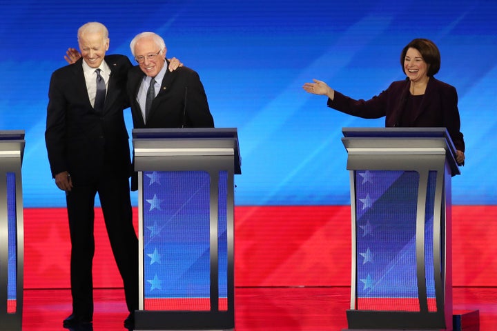 Former vice president Joe Biden and Sen. Bernie Sanders embrace at the Democratic presidential primary debate Friday night in Manchester, New Hampshire.