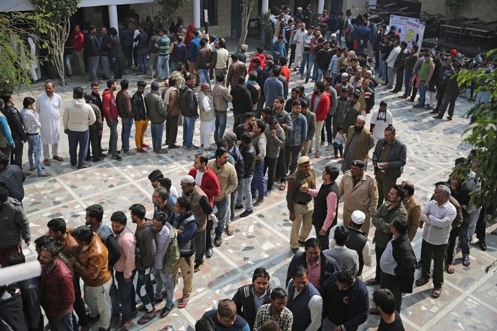 People wait for their turn to cast their vote at a polling station closest to the Shaheen Bagh protest in New Delhi,, Feb. 8, 2020.