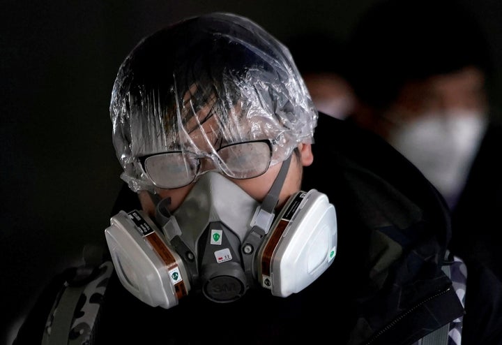 A passenger wearing a mask walks outside the Shanghai railway station in Shanghai, China, as the country is hit by an outbreak of the novel coronavirus, February 8, 2020. REUTERS/Aly Song TPX IMAGES OF THE DAY