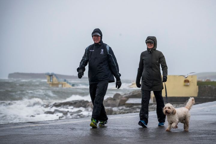 People walking their dog on Salthill promenade in Co. Galway as Ireland and the UK brace for Storm Ciara.